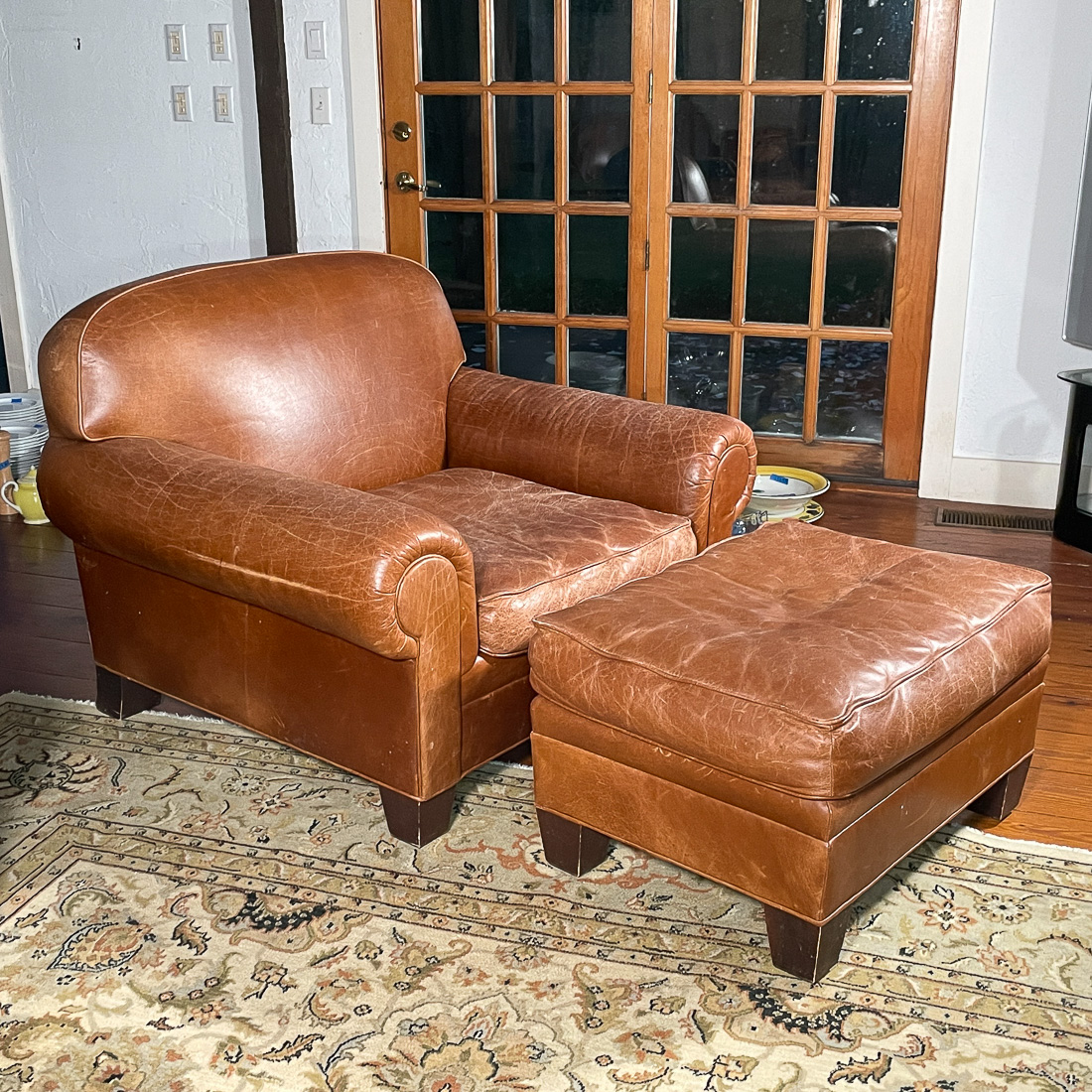 BROWN LEATHER ARMCHAIR & OTTOMAN